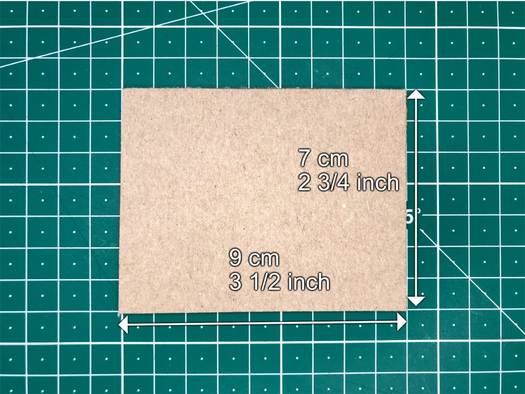 Cardboard rectangle of the right dimensions prepared for cutting holes.