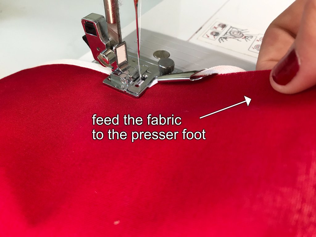 Sewing a bias binding tape to fabric edge using a presser foot for sewing bias binding tapes.