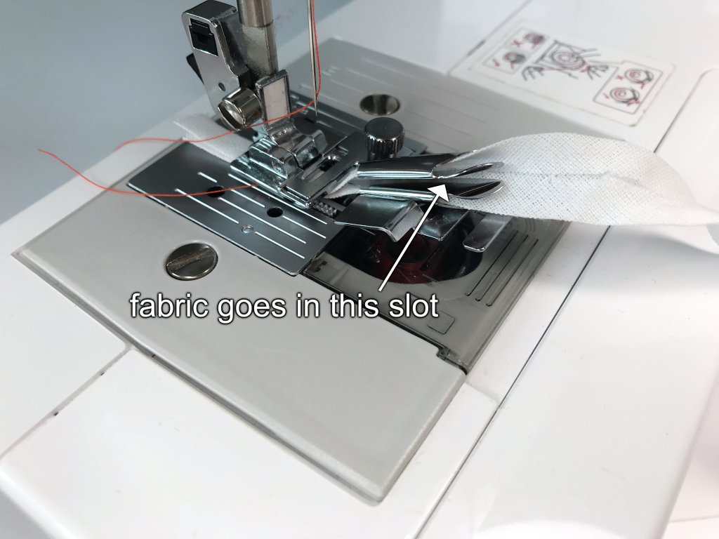 Sewing machine with a presser foot for sewing bias binding tapes.