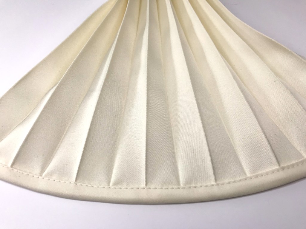 Bias binding tape applied to pleated fabric edge.