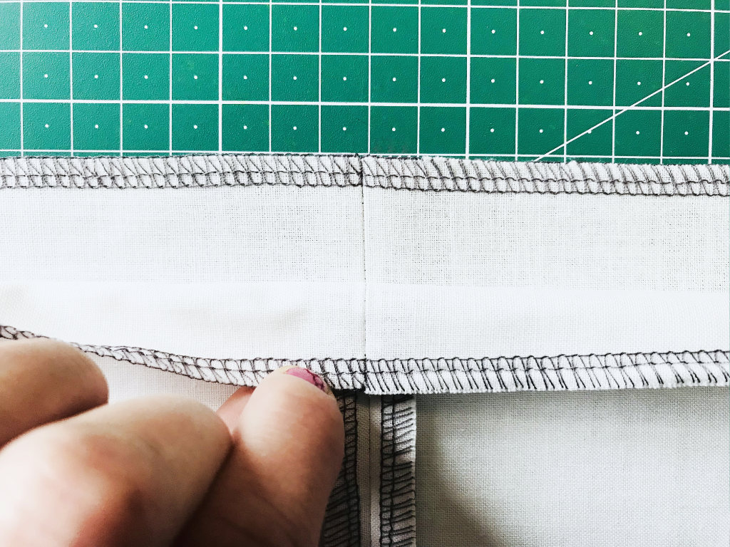 Aligning two opposite seams before sewing.