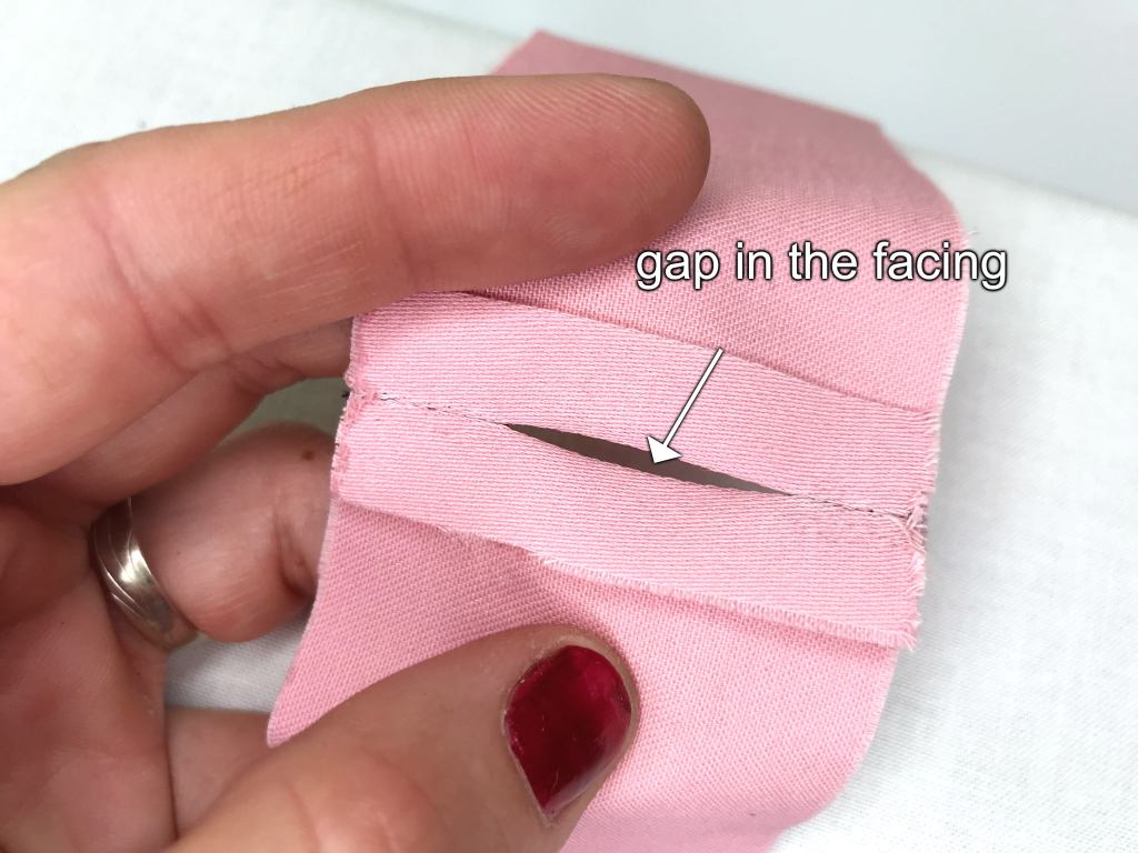 Gap in the middle of the facing that will be used to insert an elastic into a waist band casing.