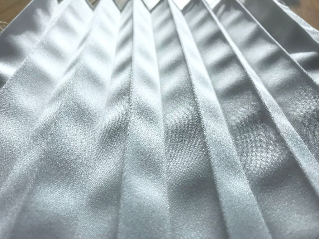 Distorted accordion pleats by using too much steam. Pleated duchess satin.