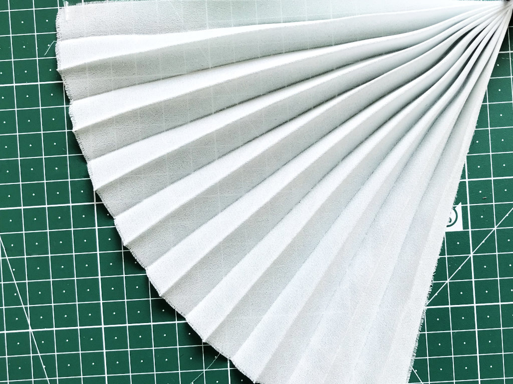 Permanently pleated georgette fabric. Permanent accordion pleats.
