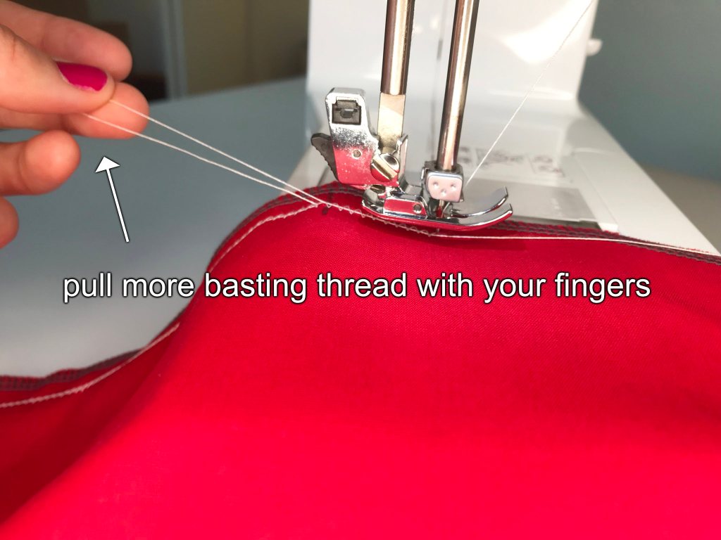 Pulling basting thread in the zig zag stitch with fingers.