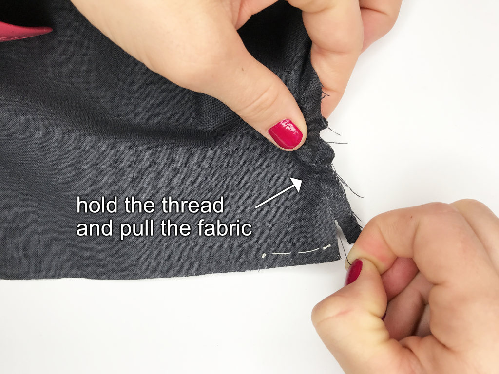 Pulling the fabric along the picked thread.