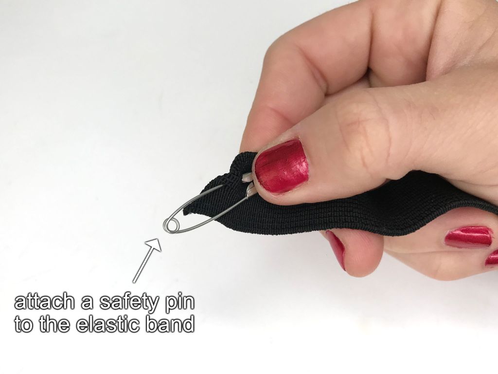 Safety pin attached to an elastic band.