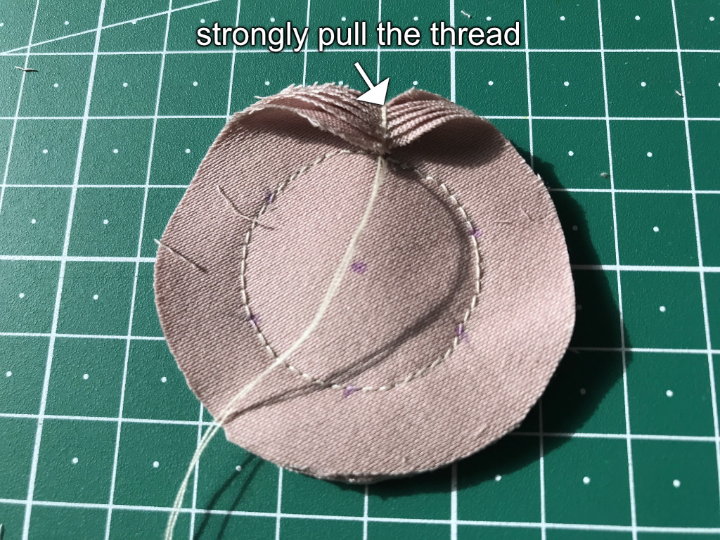 Shaping a flower petal by lopping thread around a circular shape.