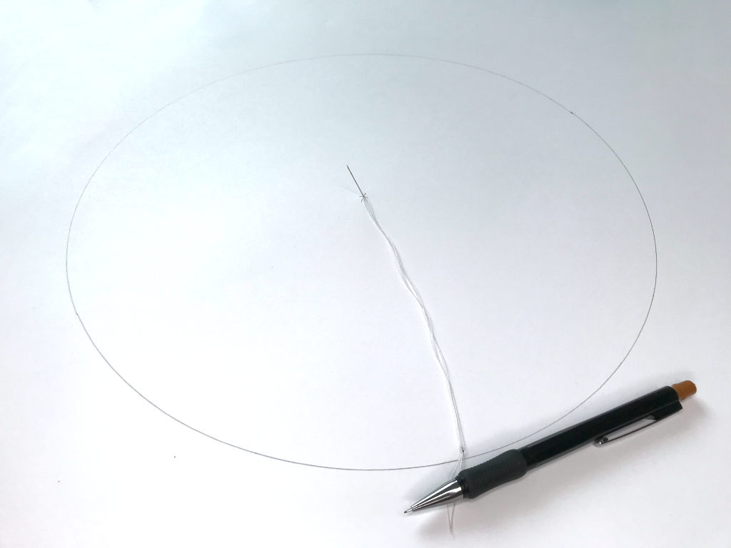 A full circle drawn by a pin, string and pencil without using a compass.