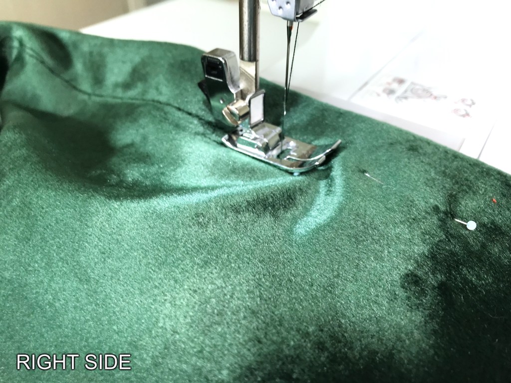 Sewing an elastic waistband casing from the right side.
