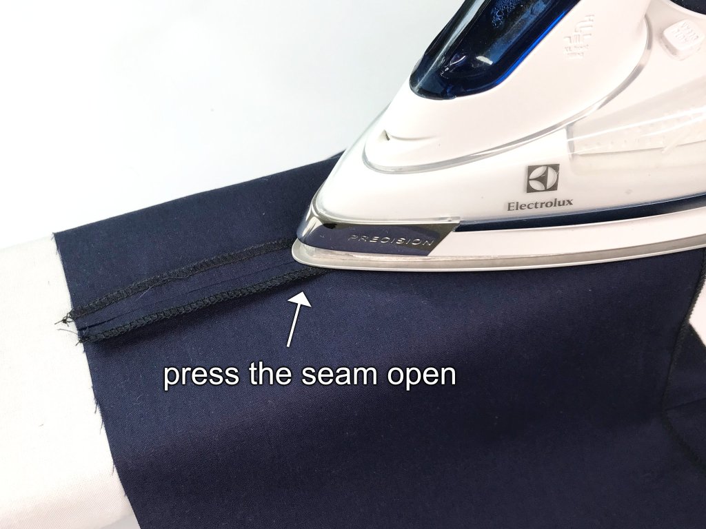 Pressing a lining fabric side seam open.