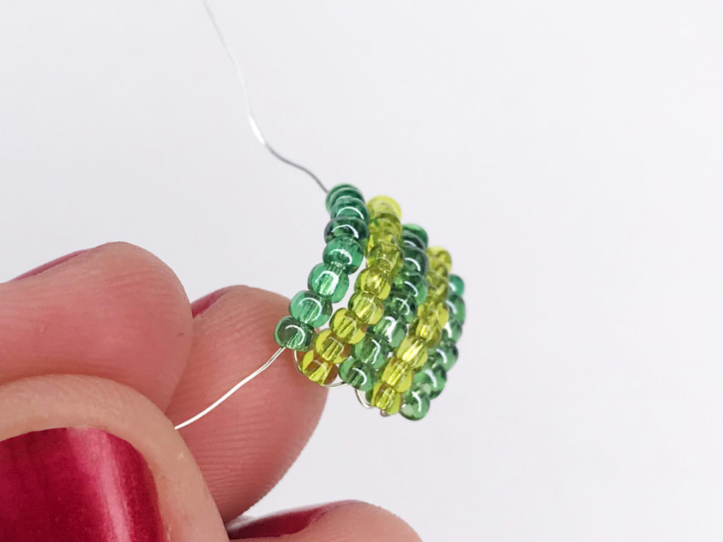 Bent leaf made of beads on a DIY Luna Lovegood earrning.