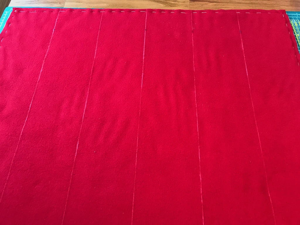 Fleece fabric rectangle divided into six equal parts.