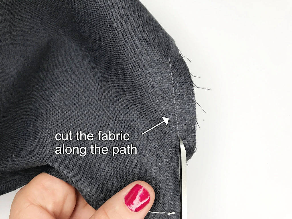 Cutting along the path created by the pulled out thread.