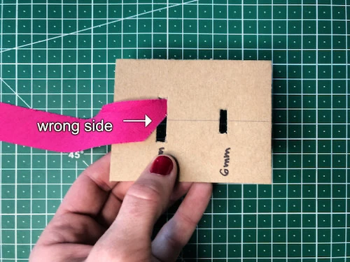 Testing the DIY bias binding tape maker with a stripe of fabric.