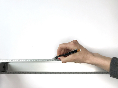 Drawing a straight long line that will become the center front of a circle skirt pattern.