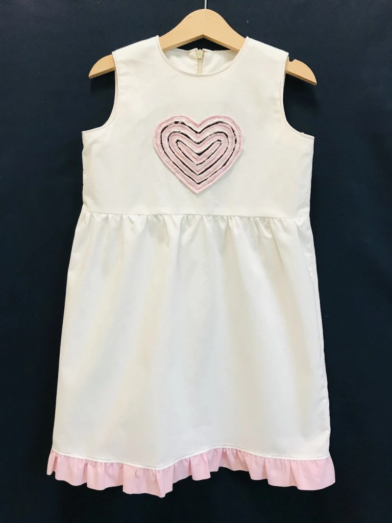 Girls sleeveless summer dress with pink heart applique - made by a sew and slash fabric manipulation technique.