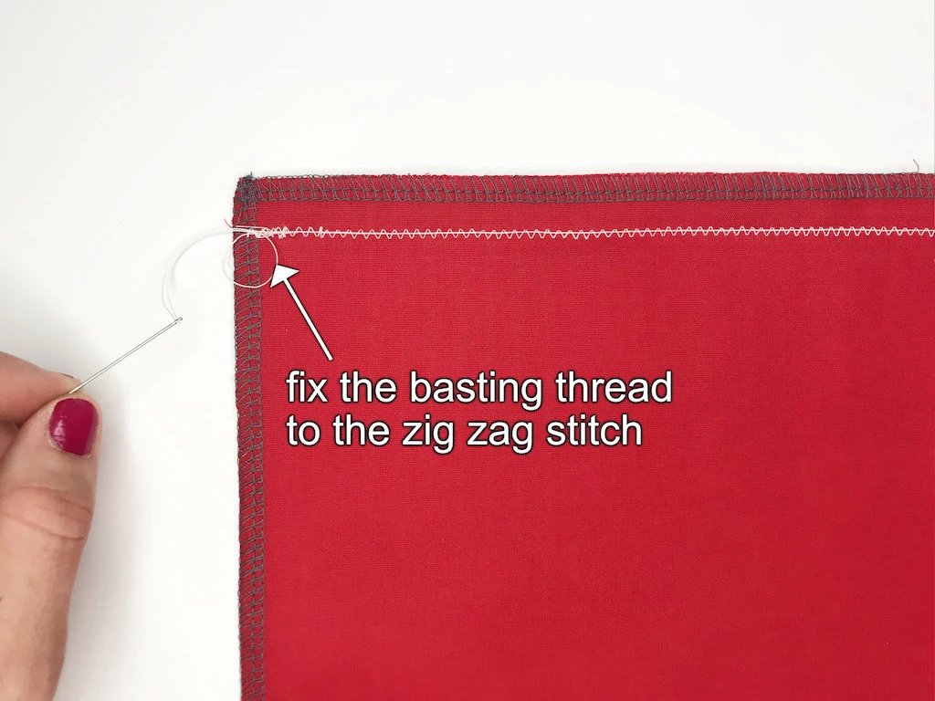 End of fabric with secured zig-zag stitch and at least 10 cm (4 inch) basting thread.