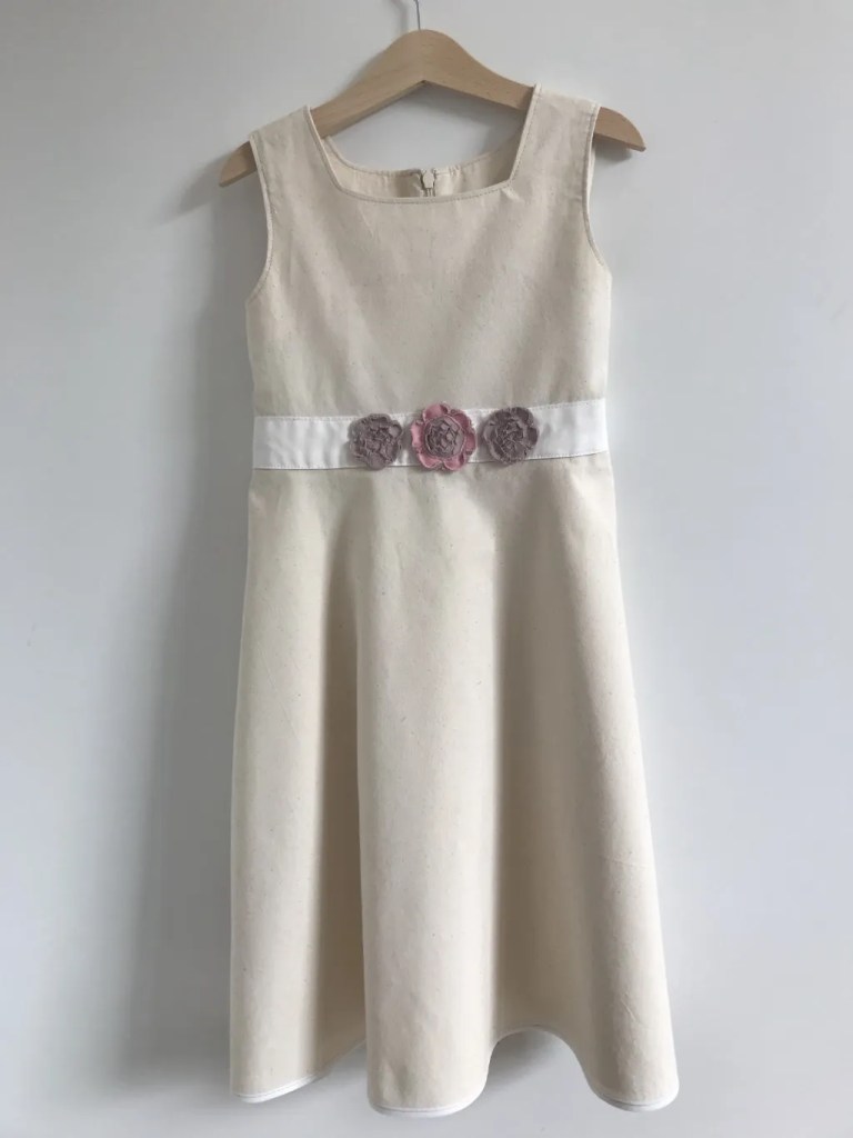 Girls' dress with a sew and slash flower applique.