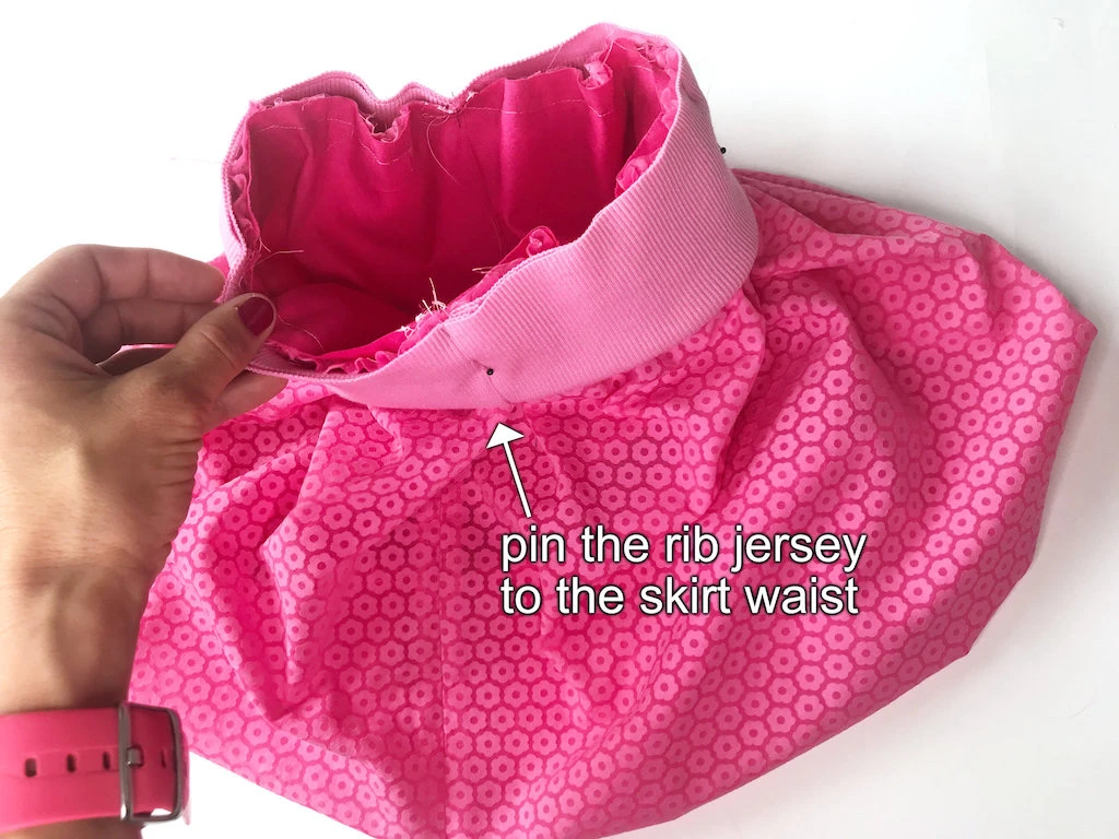 Pinning a rib jersey elastic waistband casing to a bubble skirt waist.