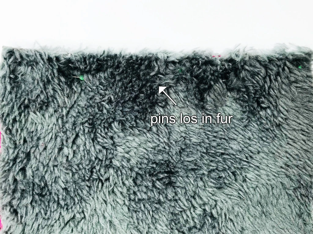 Fabric furry on the wrong side pinned along edges of fabric.