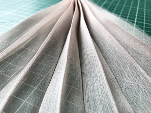 Permanently pleated chiffon fabric. Accordion pleats.
