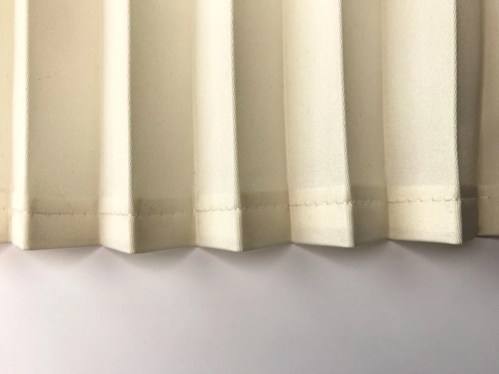 Double fold hem on pleated satin fabric.