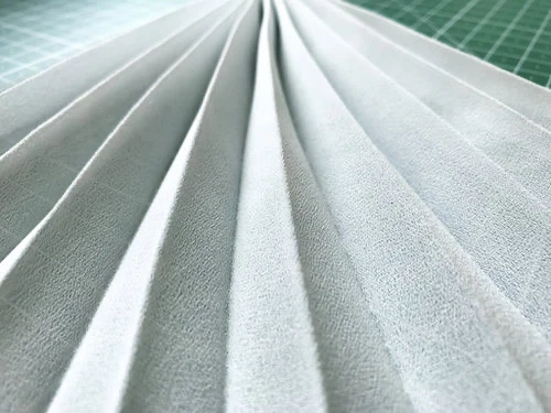 Permanently pleated georgette fabric. Permanent accordion pleats.
