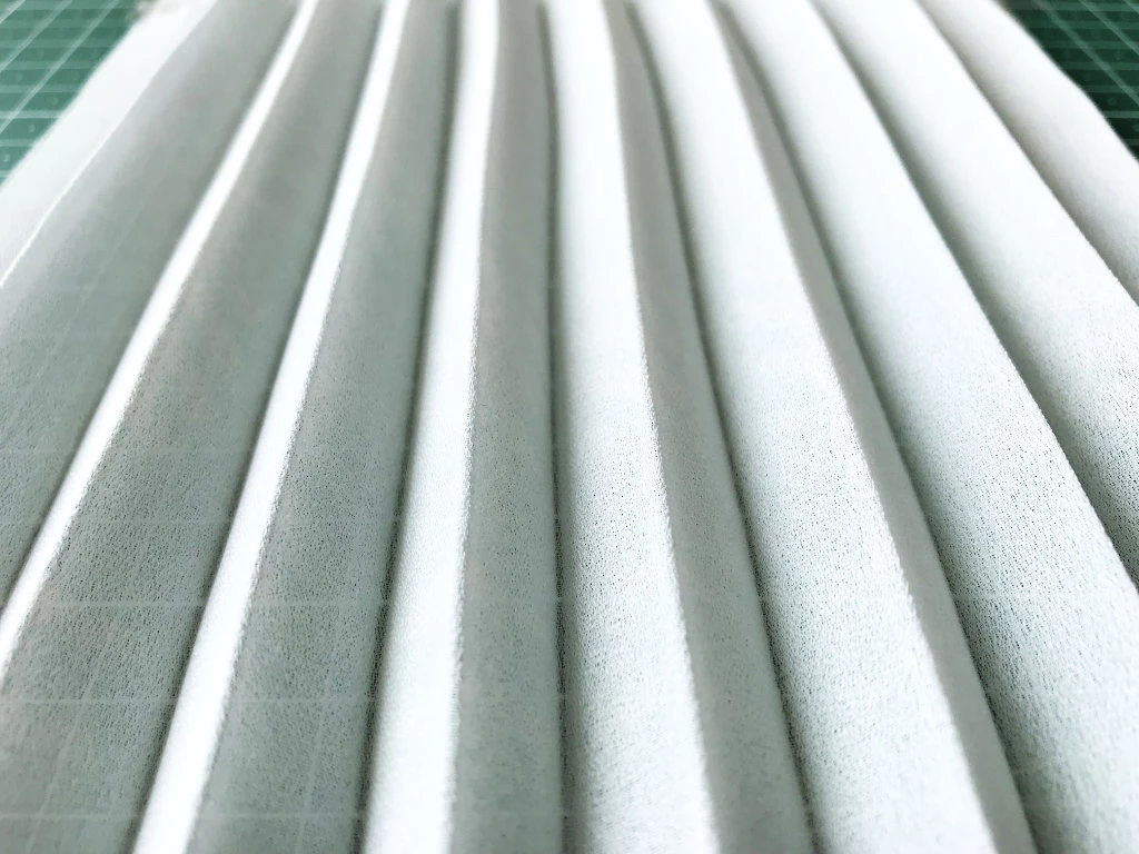 Permanently pleated georgette fabric. Permanent accordion pleats.
