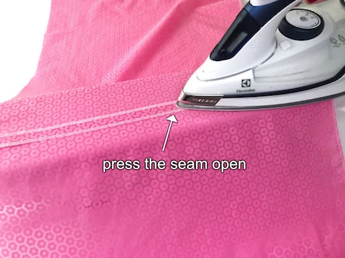 Pressing a bubble skirt side seam open.