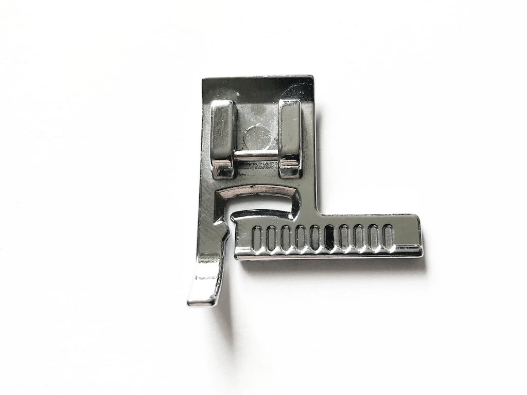 Straight piece of fabric cut away with rotary cutter along a ruler.