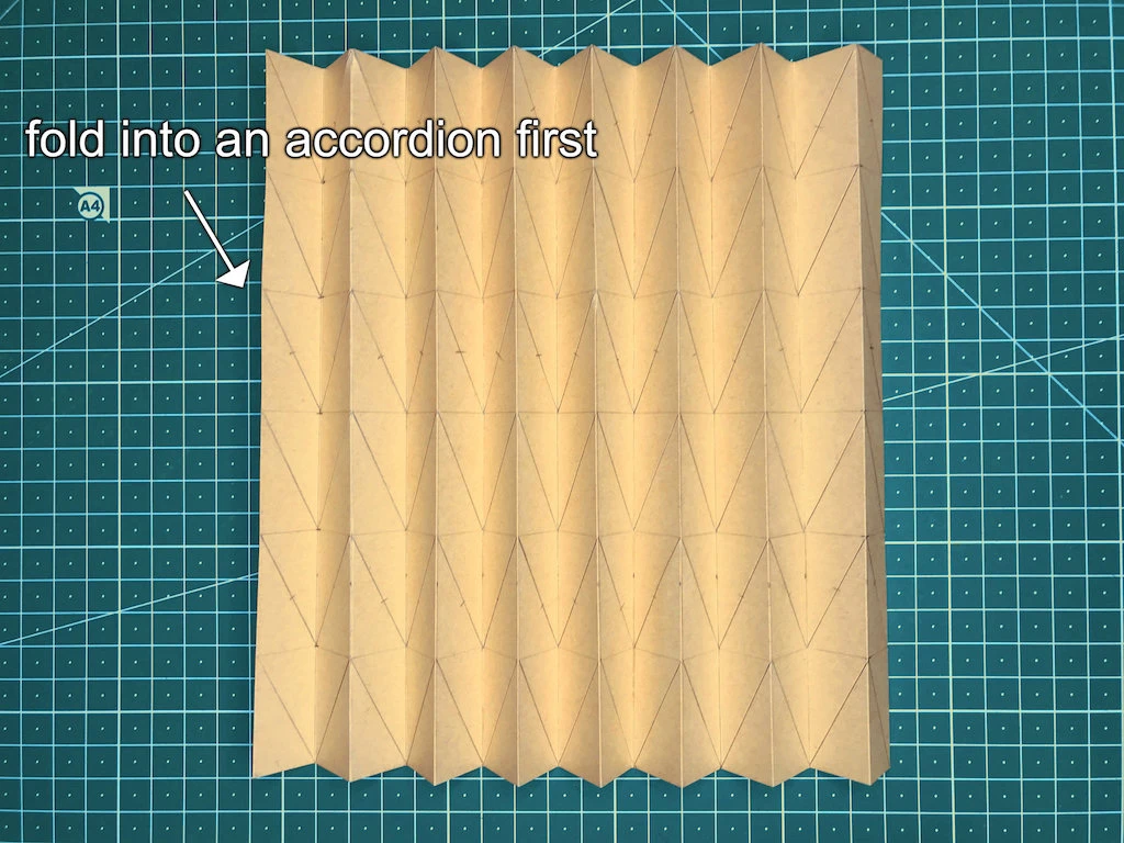 Kraft paper folded in a shape of simple accordion pleats.