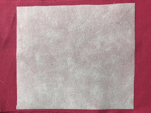 Cotton iron on and tear off stabiliser ironed to the WRONG side of the fabric.