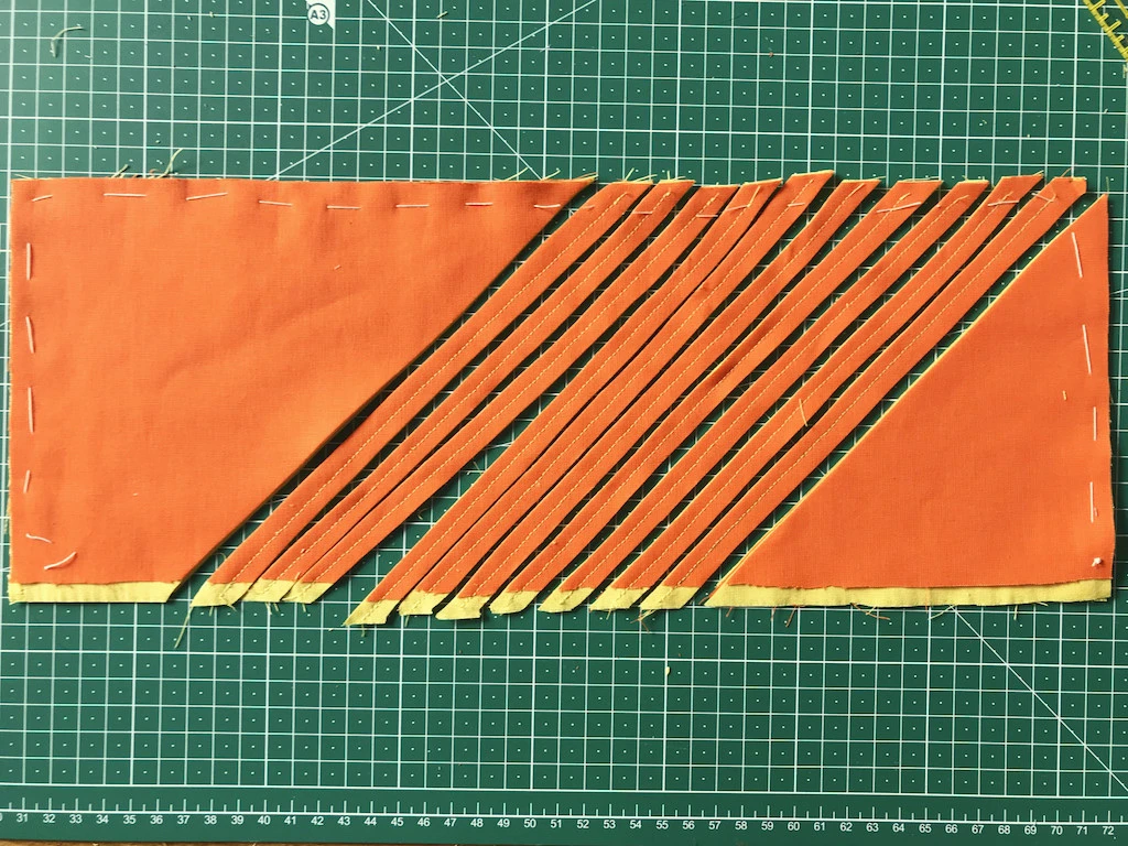 Sewing parallel lines using presser foot with a ruler.
