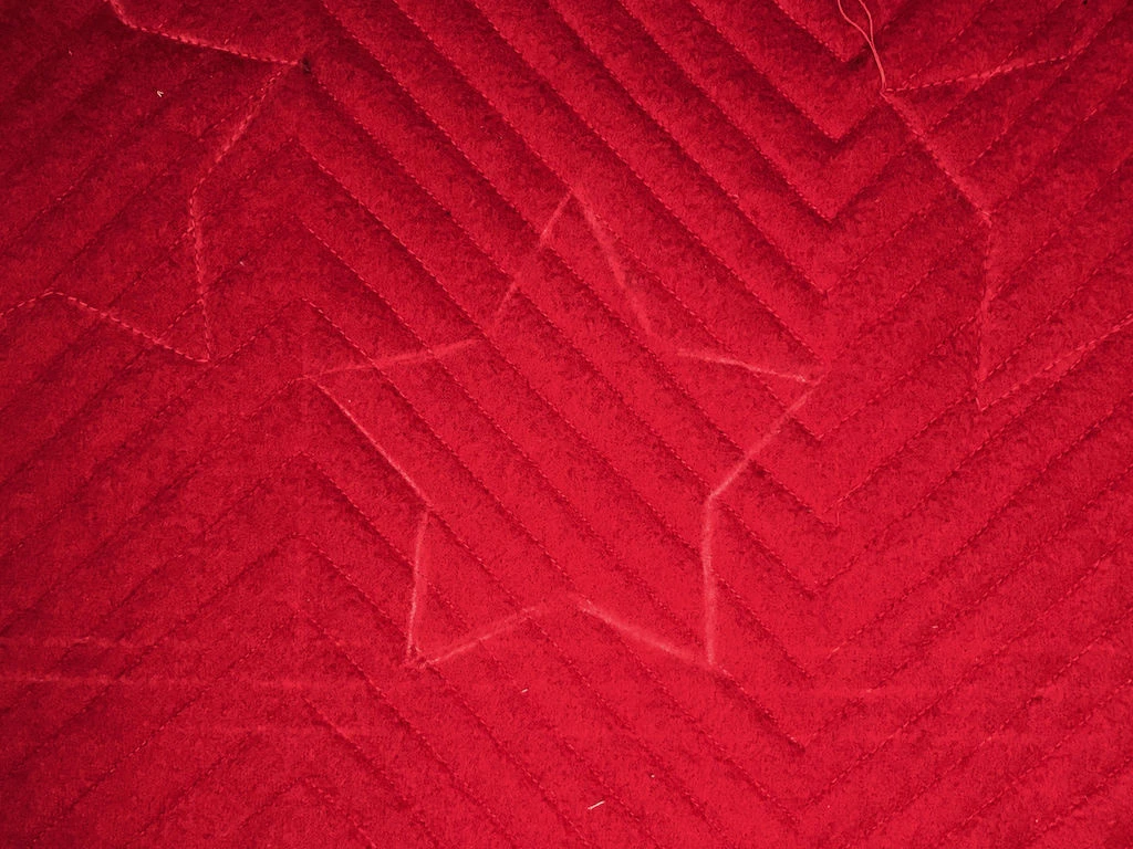 Transferring a star template to a faux chenille Christmas pillowcase.