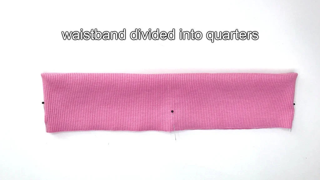 A rib jersey waistband divided into quarters by using a seam a three pins.