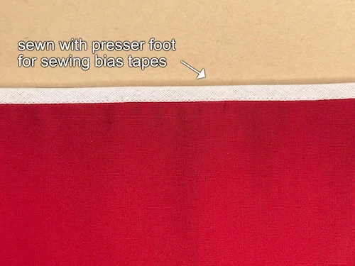 Bias tape sewn to hem.