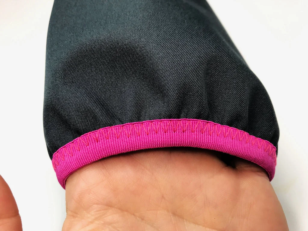 Sleeve edge with a fold-over elastic trim and decorative zigzag stitch.