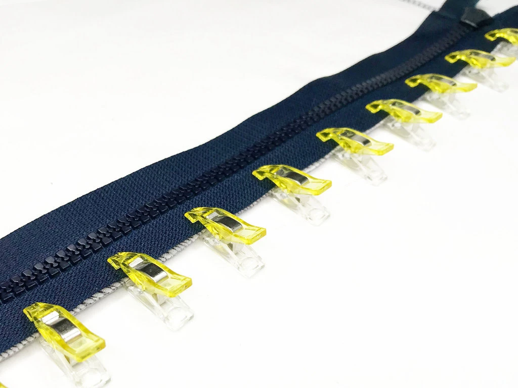 Zipper attached to fabric with sewing clips.