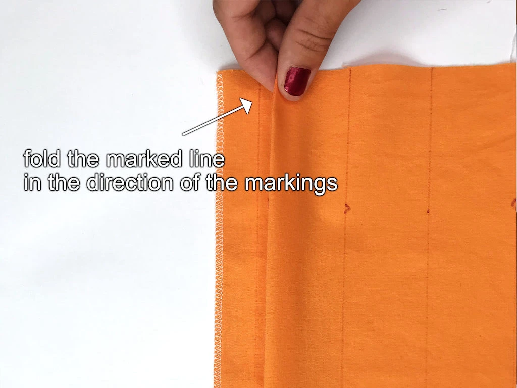 Folding box pleats before sewing.