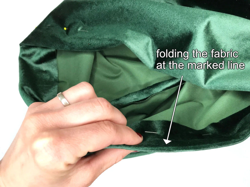 Folded fabric creating an elastic waistband casing.