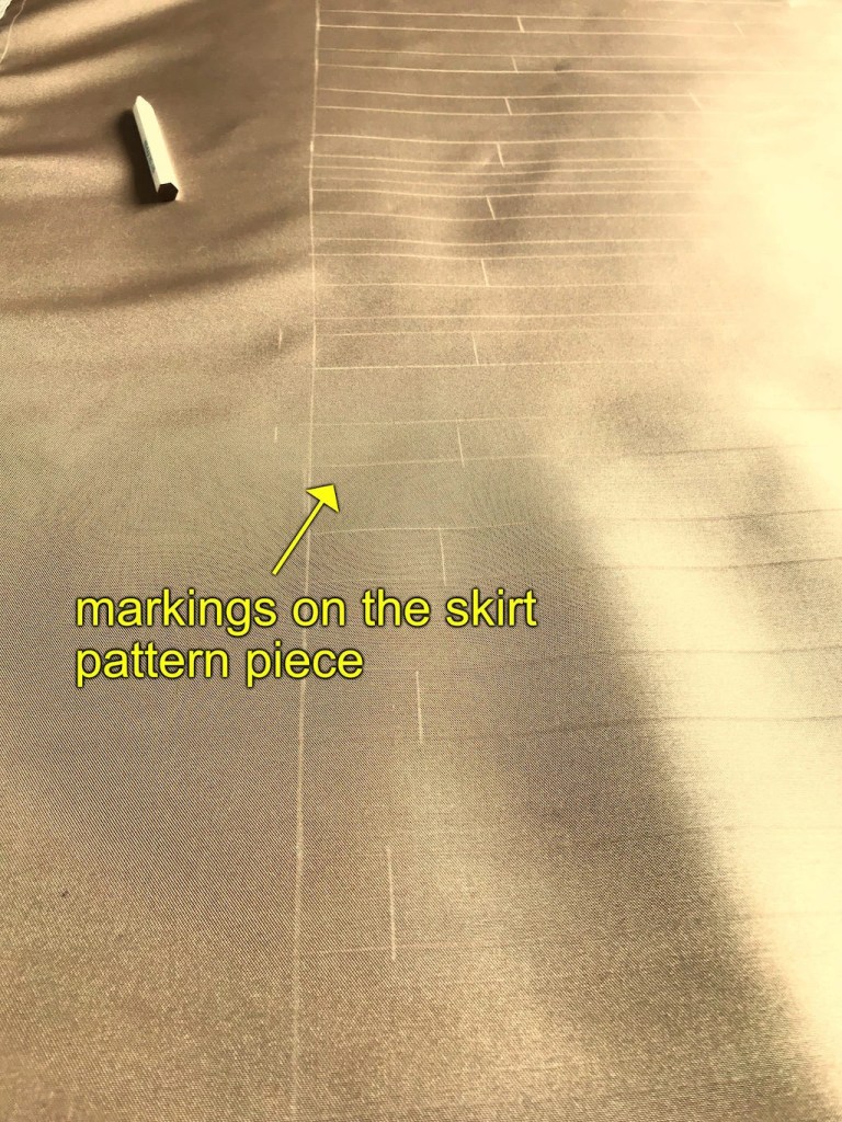 Tuck lines on the wrong side of beige satin fabric.
