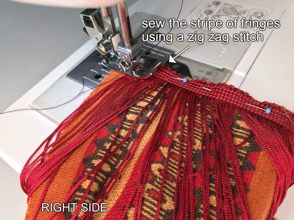 Sewing fringe trim to a headband end.