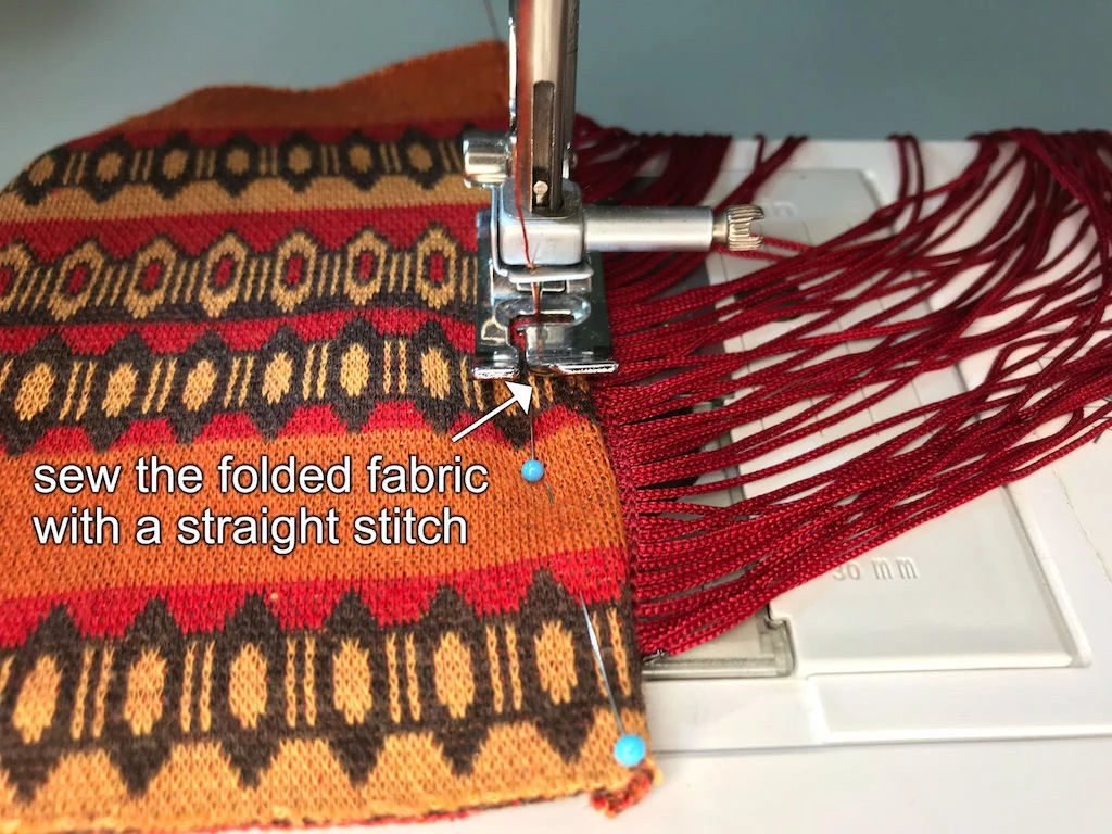 Sewing fringes to a fabric with a straight stitch.