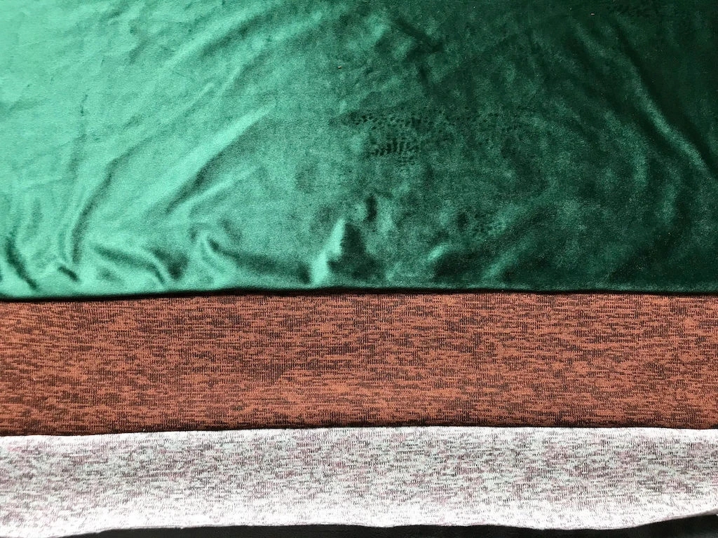 Stripes of green, brown and pink fabrics sewn together making a full Sybill Trelawney skirt length.