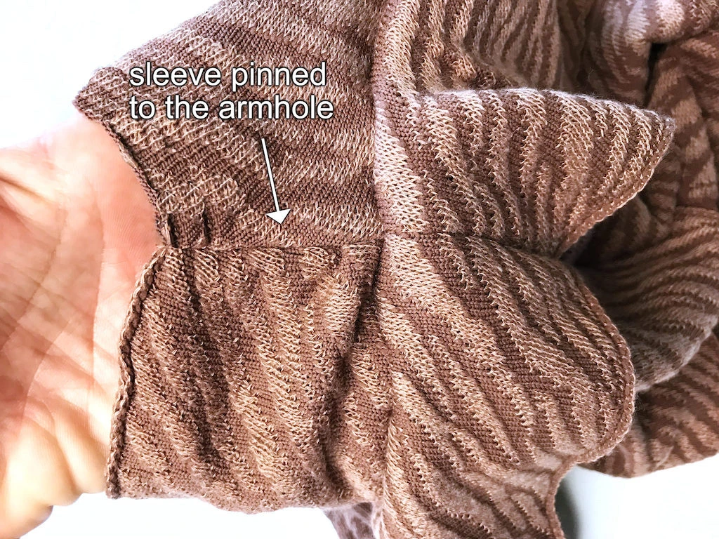 Sleeve pinned to armhole.