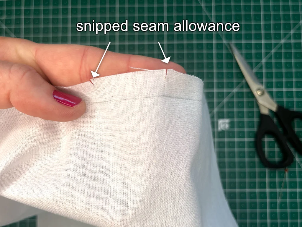 Snips indicating dart legs on the seam allowance.