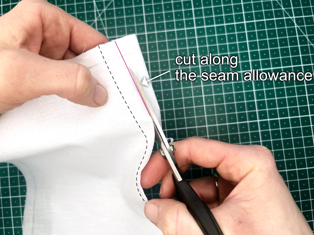 Trimming dart bulk along pre-drawn seam allowances.